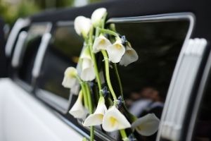 white flowers seen thru window of a limo