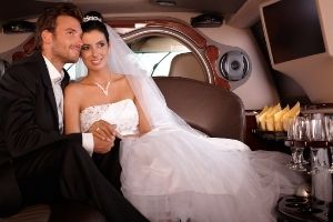 bride and groom in a limo