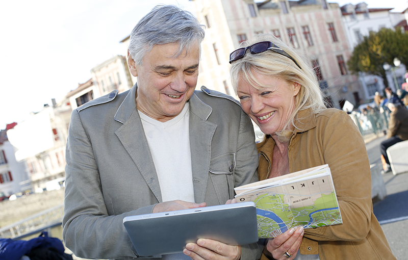 elderly couple looking at a map